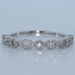 Silver bracelet with diamond accents on a light gray background