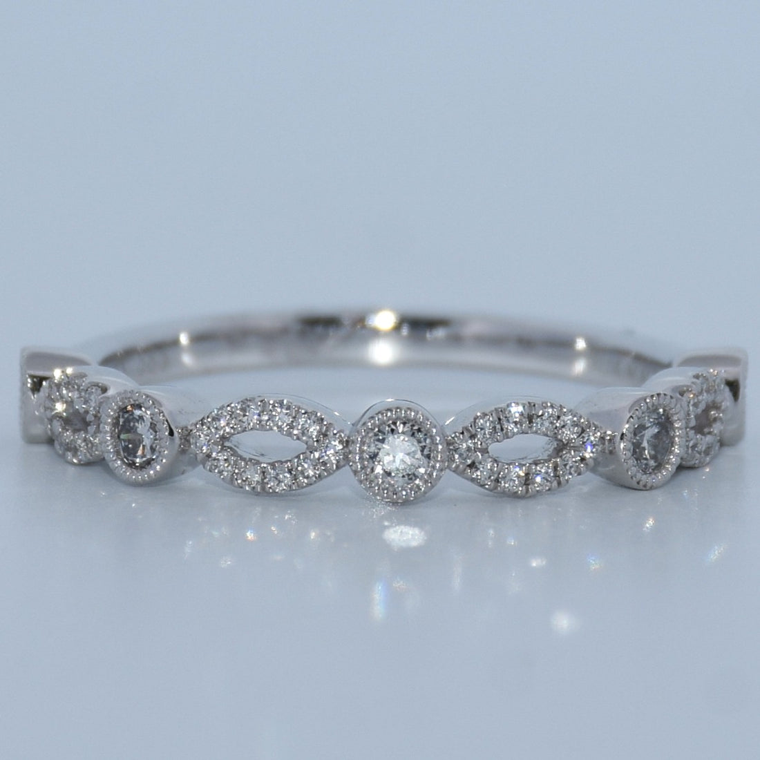 Silver bracelet with diamond accents on a light gray background