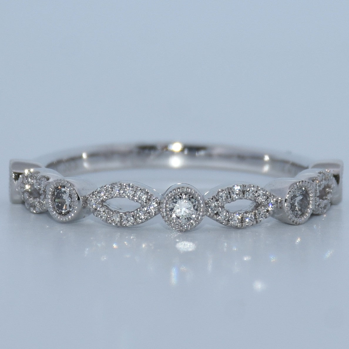 Silver bracelet with diamond accents on a light gray background