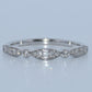 WG ring with diamond stones on a light gray background