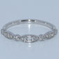 Silver ring with diamond stones on a light gray background