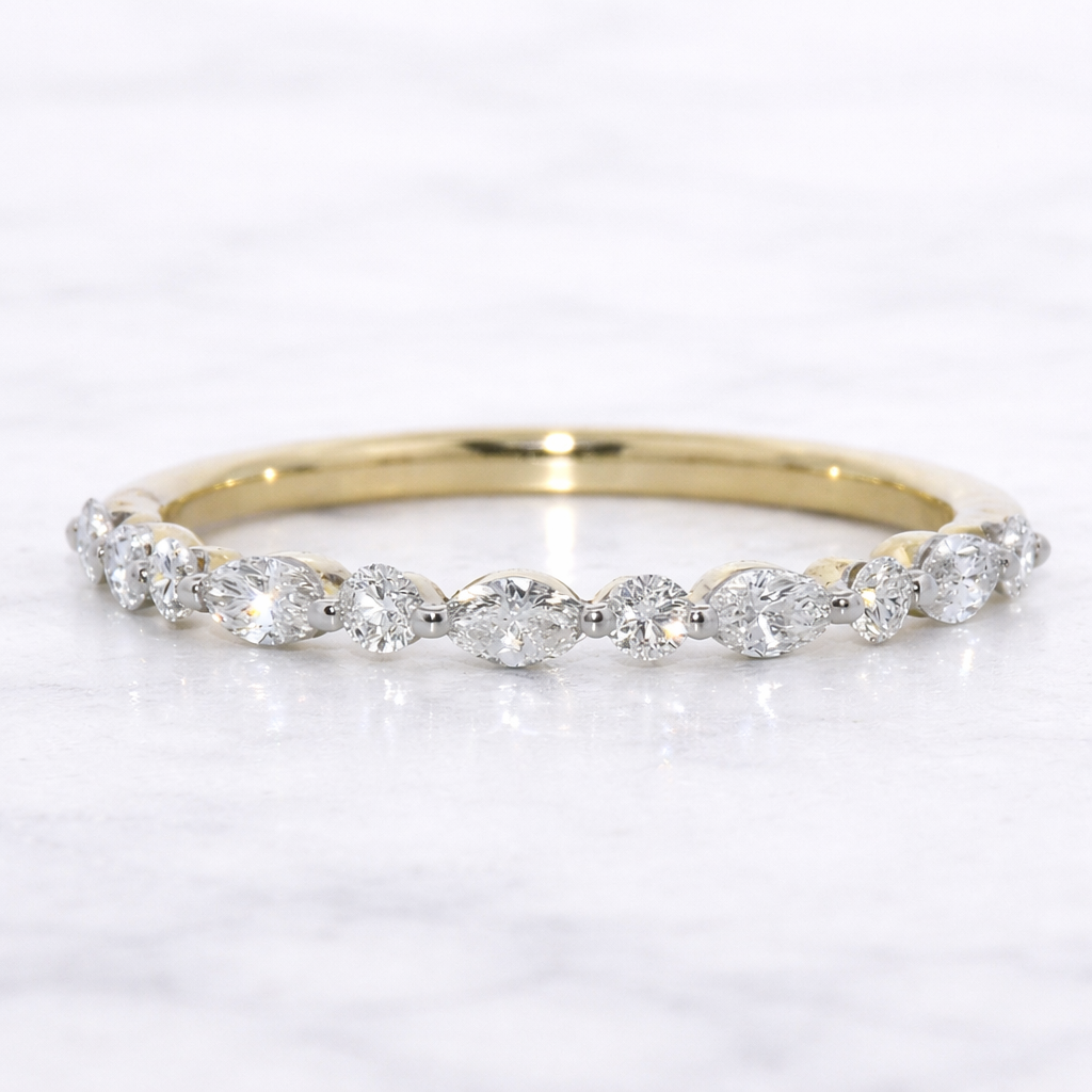 Gold ring with diamonds on a white background