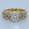 Gold ring with a diamond on a white background