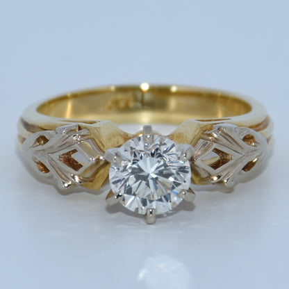 Gold ring with a diamond on a white background