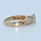 Gold ring with a diamond on a light blue background