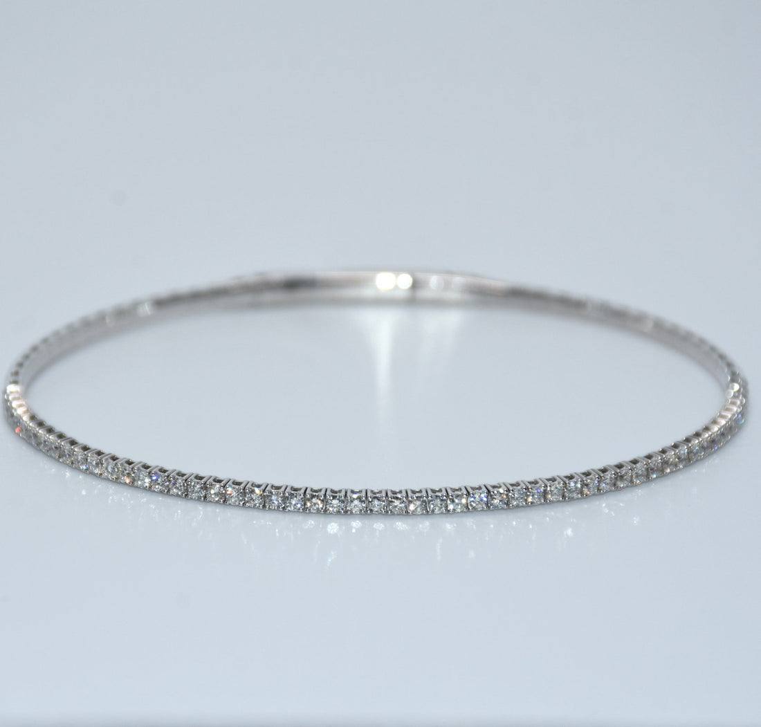 Silver bracelet with small stones on a light gray background