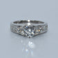 Silver ring with multiple diamonds on a light gray background