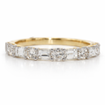 Gold ring with diamond stones on a white background