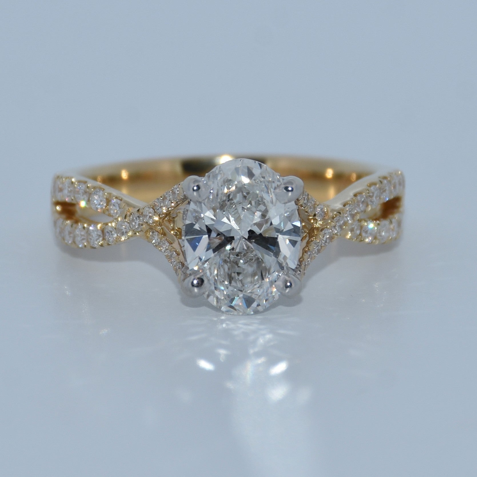 Gold ring with a diamond on a light gray background