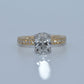 Diamond ring with gold band on a light gray background