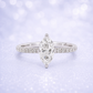 Diamond ring with a marquise-shaped center stone on a soft, blurred  background 14K Gold | 1CT Marquise Lab Grown Diamond Bridal Ring Set with Matching Wedding Band - White Gold