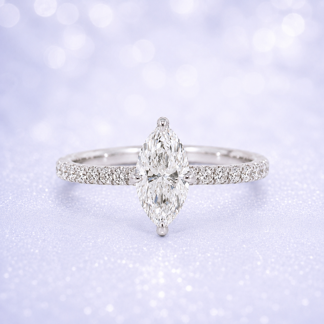 Diamond ring with a marquise-shaped center stone on a soft, blurred  background 14K Gold | 1CT Marquise Lab Grown Diamond Bridal Ring Set with Matching Wedding Band - White Gold