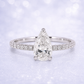 Diamond ring with pear-shaped center stone on a light background 14K Gold | 1CT Pear Lab Grown Diamond Bridal Ring Set with Matching Wedding Band - White Gold