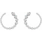 Set of silver hoop earrings with clear gemstones on a white background
