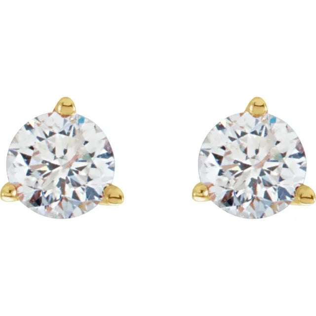 Gold earrings with clear gemstones on a white background