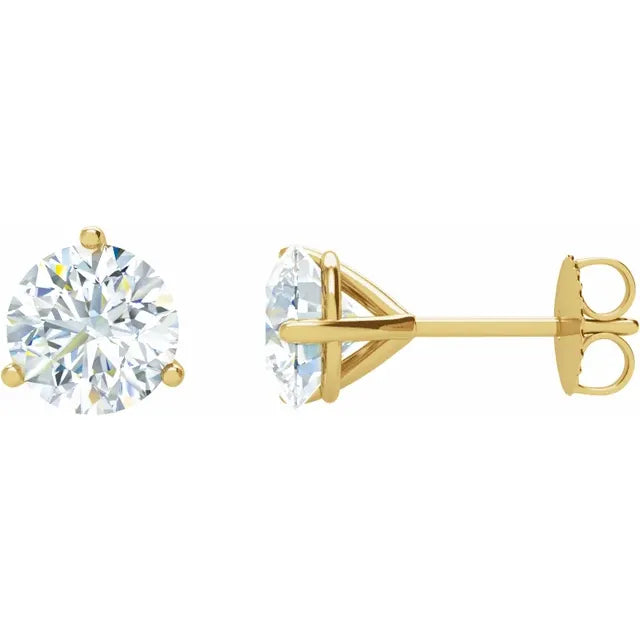 Gold stud earrings with clear gemstones on a white background