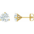 Gold stud earrings with clear gemstones on a white background