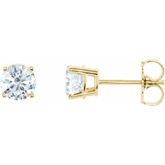 Gold stud earrings with clear gemstones on a white background