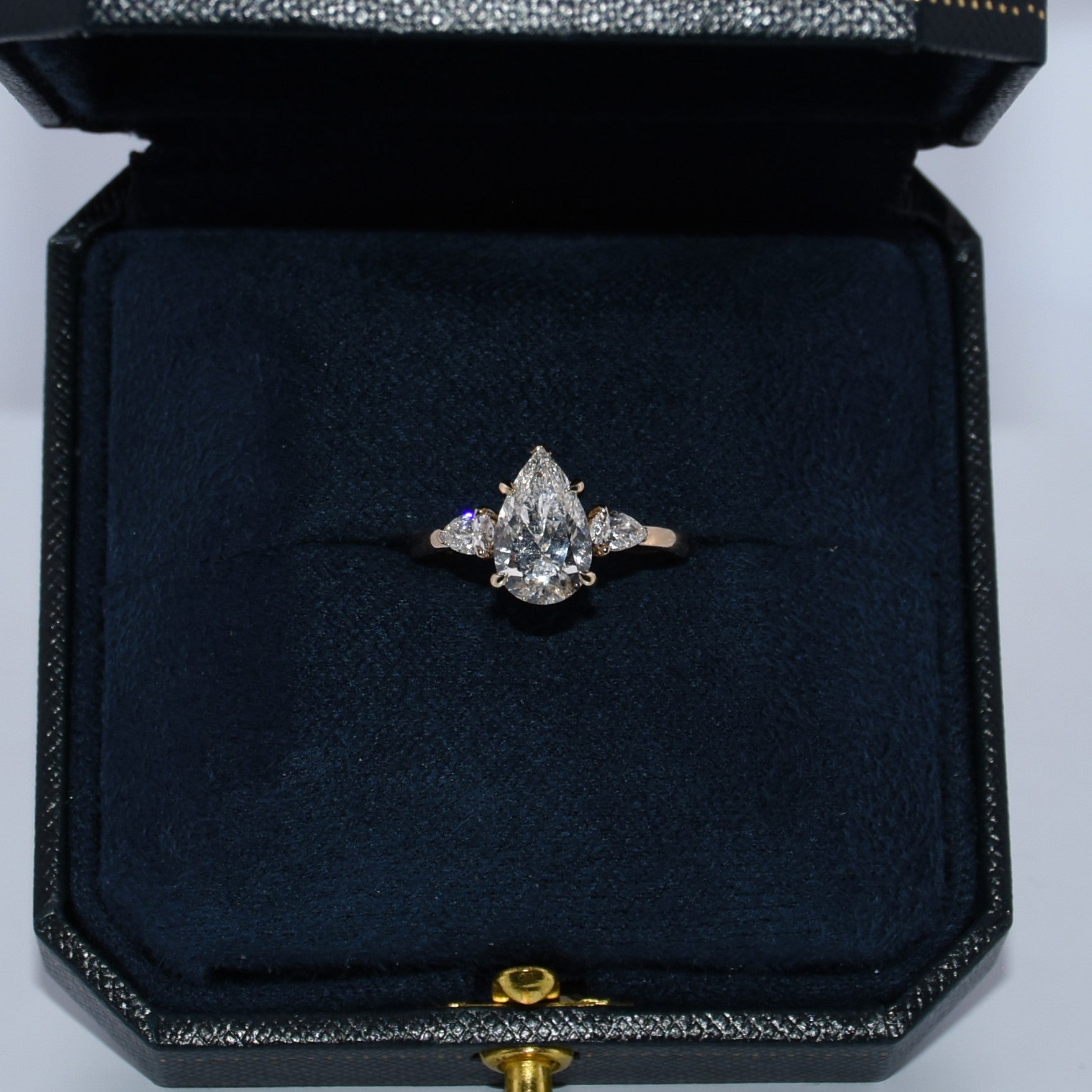 Diamond ring in a black jewelry box on a white background