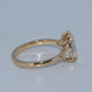 Gold ring with a diamond on a light gray background
