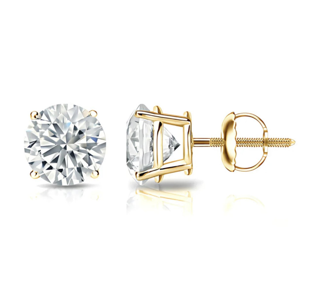 Gold stud earrings with clear gemstones on a white background