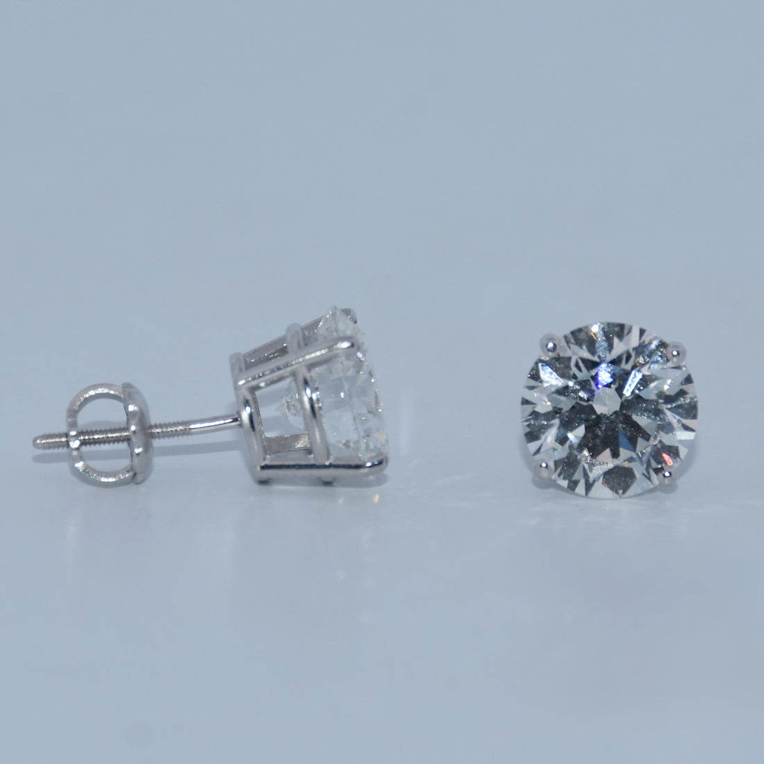 Diamond stud earring on a light gray background