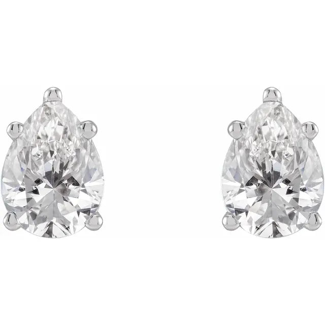 Pair of pear-shaped diamond earrings on a white background
