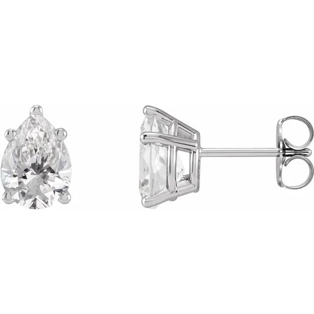 Two diamond earrings on a white background