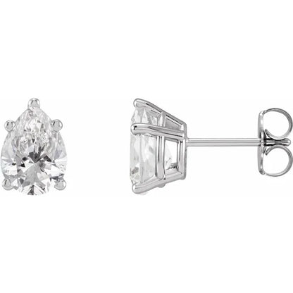Two diamond earrings on a white background