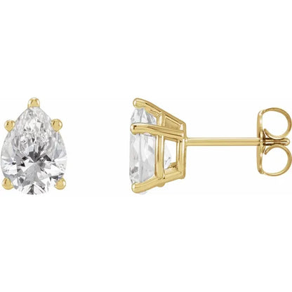 Gold earrings with clear gemstones on a white background