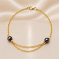 Gold bracelet with black pearls on a beige background 14K Gold | Black Pearl Chain Bracelet