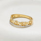 A yellow gold Irish ring featuring a continuous band of cut claddagh links and hearts, with a single row of small clear pavé stones along the front. The inner band is stamped with '14K' and 'Shannon'. 14K Gold | Claddagh Ring with Lab Diamonds Border