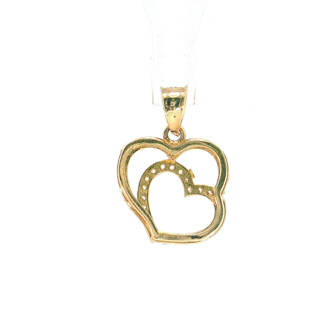 A gold heart-shaped pendant with an openwork design and a smaller inner heart outlined with small stones, suspended on a clear display stand against a white background.