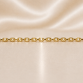 Gold chain on a beige satin background 14K Gold Elongated Link Chain Necklace