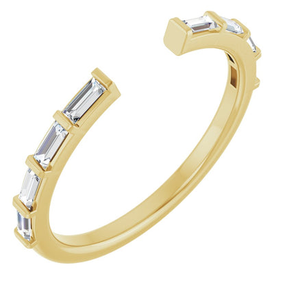Gold ring with baguette cut diamonds on a white background