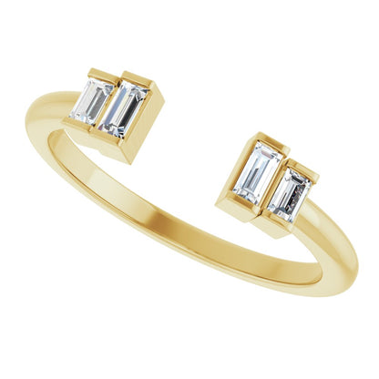 Gold ring with baguette-cut gemstones on a white background