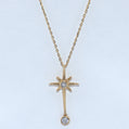 Gold necklace with star-shaped pendant on a light blue background