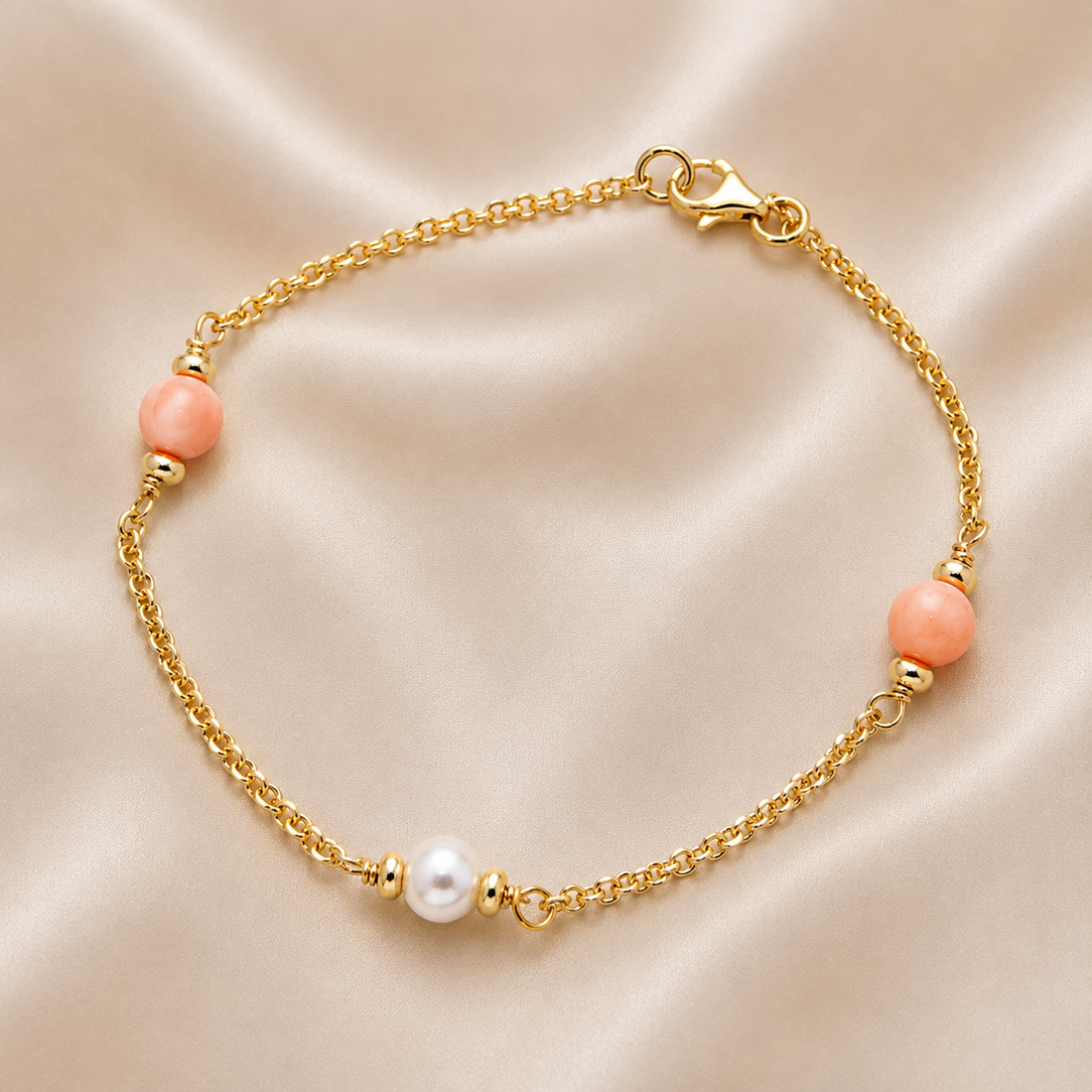 Gold bracelet with pink beads on a beige fabric background 14K Gold | Pink & White Pearl Bracelet