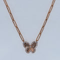 Rose gold butterfly necklace on a light gray background