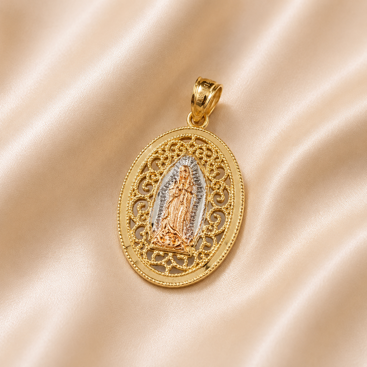 Gold pendant with intricate design on a beige fabric background 14K Gold | Round Tricolor Filigree Virgin Mary Pendant
