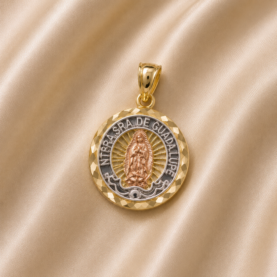 Gold and silver pendant with 'Nuestra Señora de Guadalupe' on a beige fabric background 14K Gold | Round Tricolor NTRA. SRA. De Guadalupe