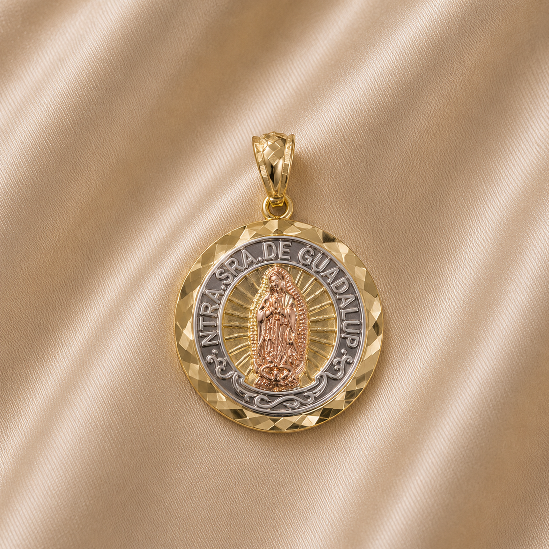 Gold and silver pendant with religious figure on a beige fabric background 14K Gold | Round Tricolor NTRA. SRA. De Guadalupe 