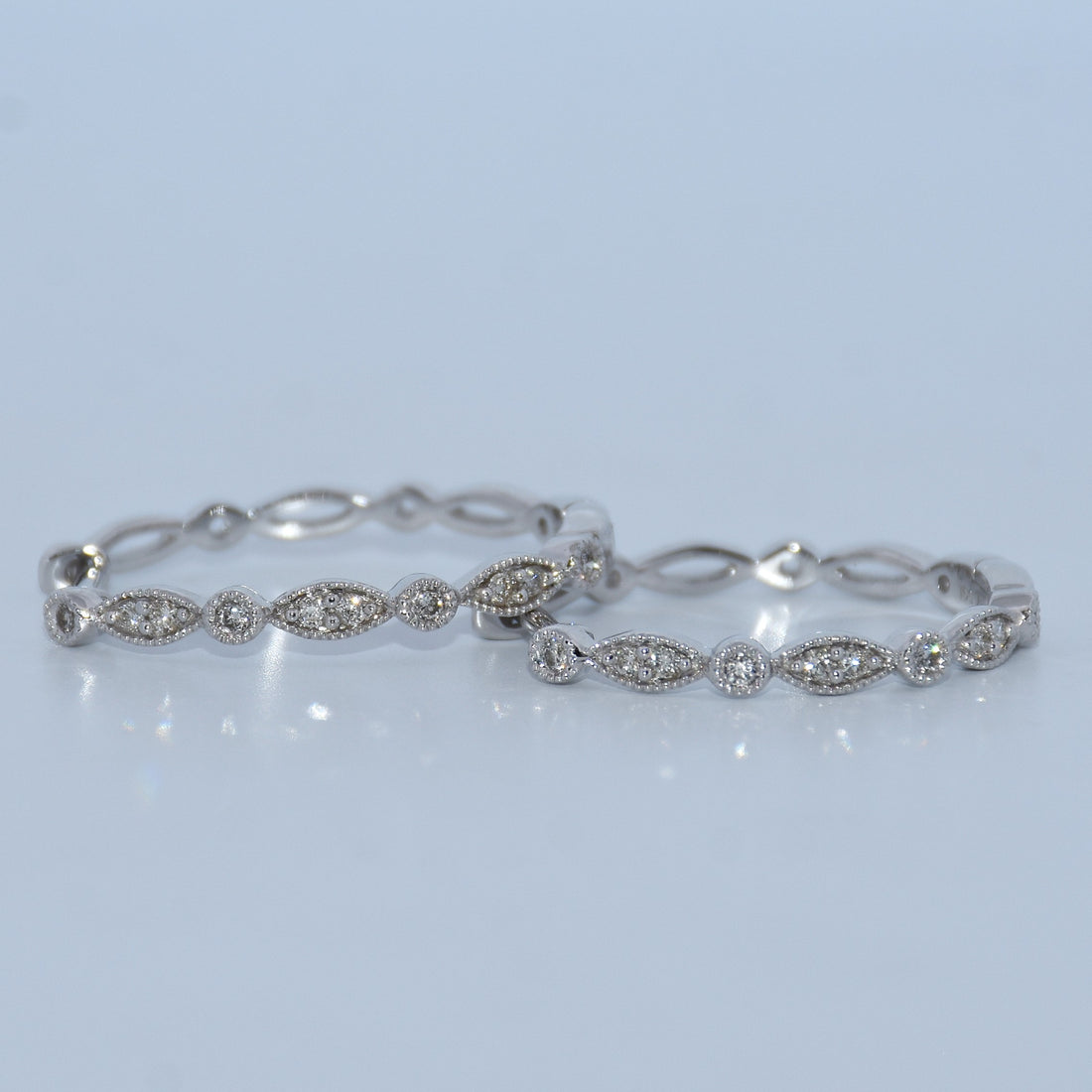 Silver bracelet with diamond accents on a light gray background