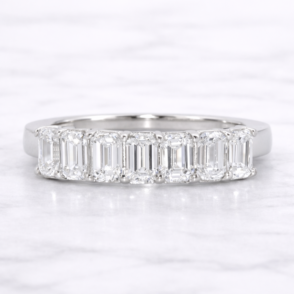 Diamond ring with baguette-cut stones on a white background