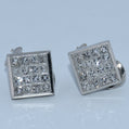 Pair of square-shaped silver cufflinks with gemstones on a light gray background