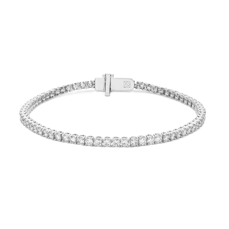 Silver bracelet with diamond accents on a white background