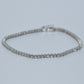 Silver bracelet on a light gray background