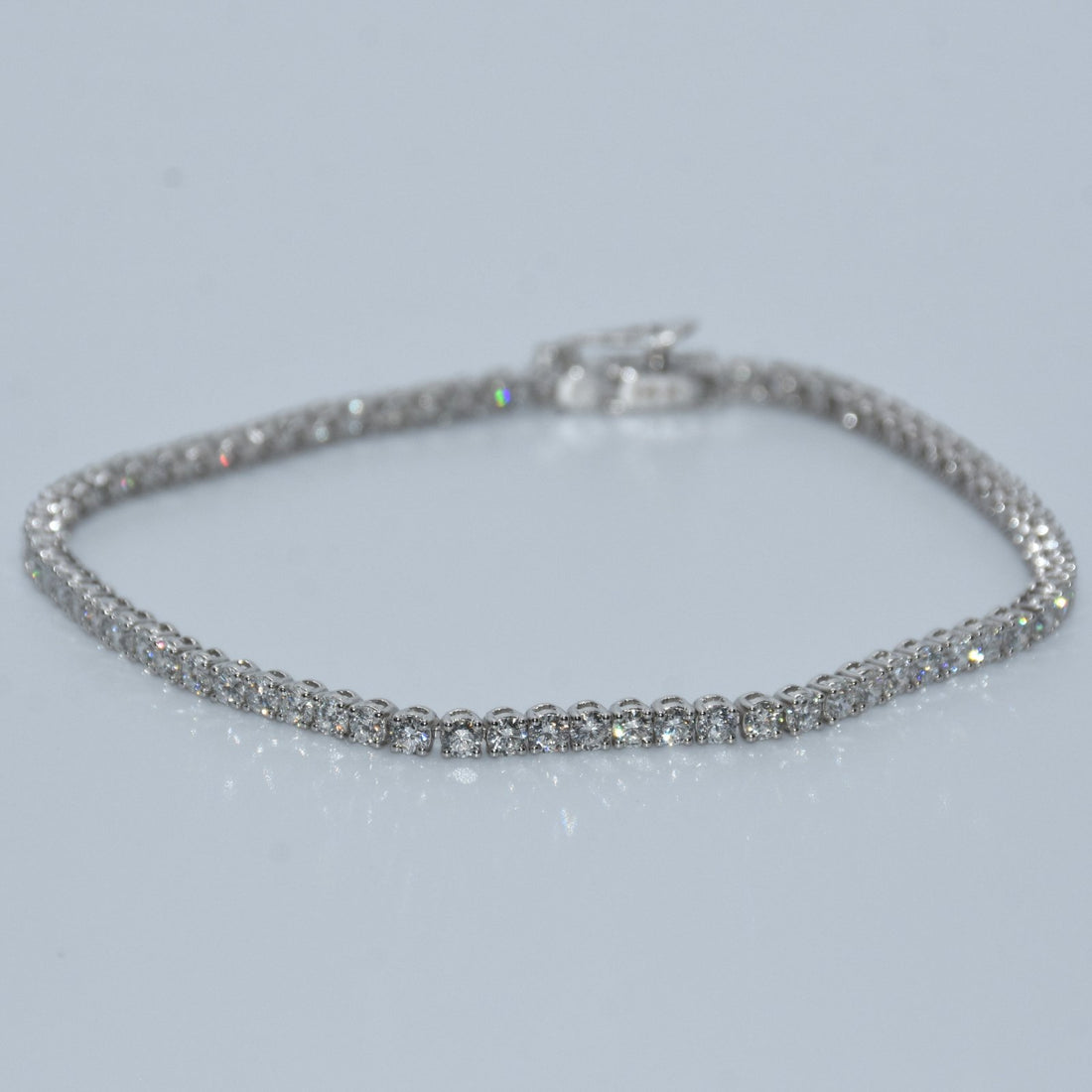 Silver bracelet on a light gray background