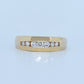 Gold ring with diamonds on a light blue background