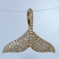Gold and diamond pendant on a light blue background